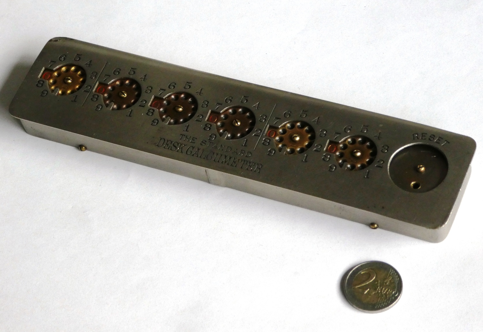 Figure 8 — A six-dial Calcumeter, nickel-plated, with its reset wheel at the right.