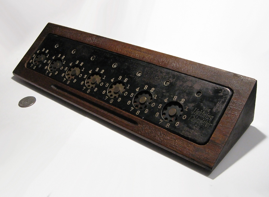 Figure 2 — Grand Rapids: a black Lightning Calculator on its wedge-shaped wooden base.