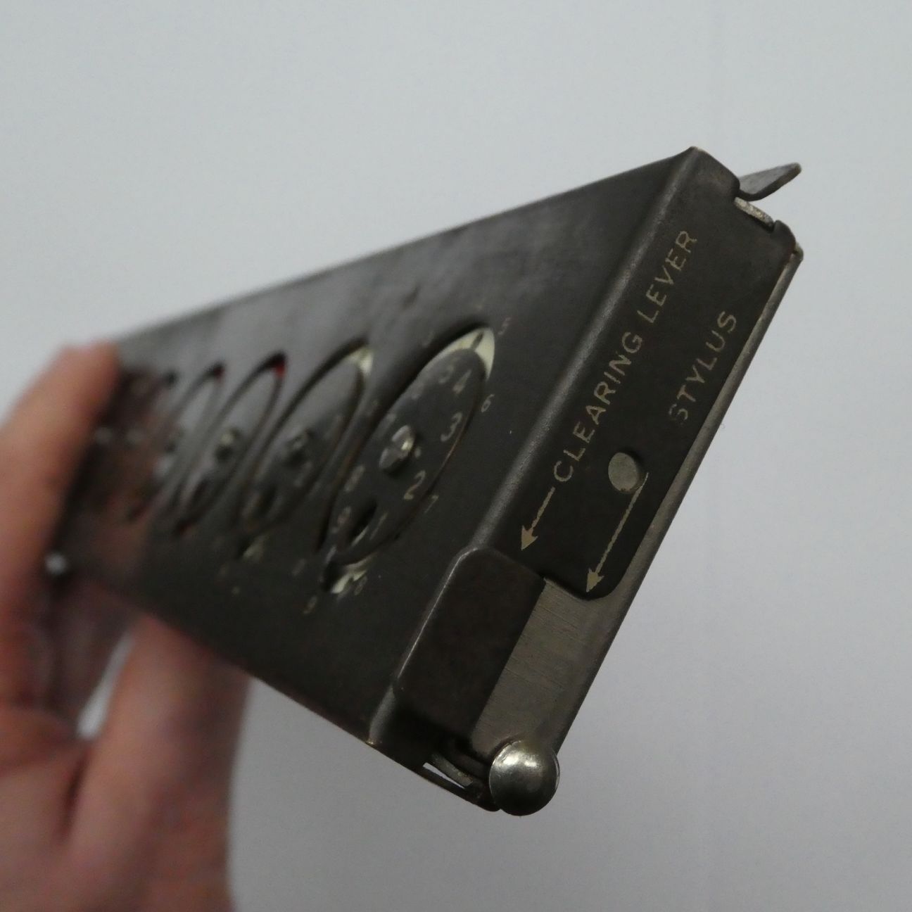 Figure 5 — The Addometer's working end: the clearing lever and the stylus housing are marked on the case.