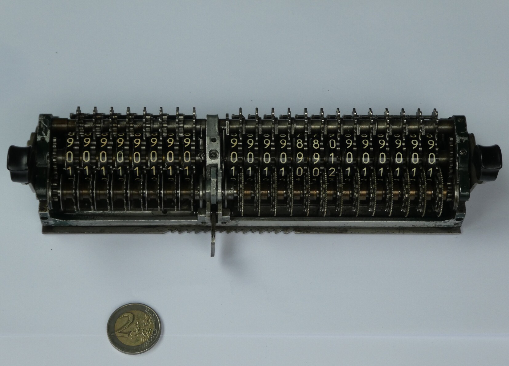 Figure 14 — The carriage of a Manus E removed from the machine: the 8-place revolutions counter at the left and the 13-place result register at the right, with the rows of pinions underneath that mesh with the…
