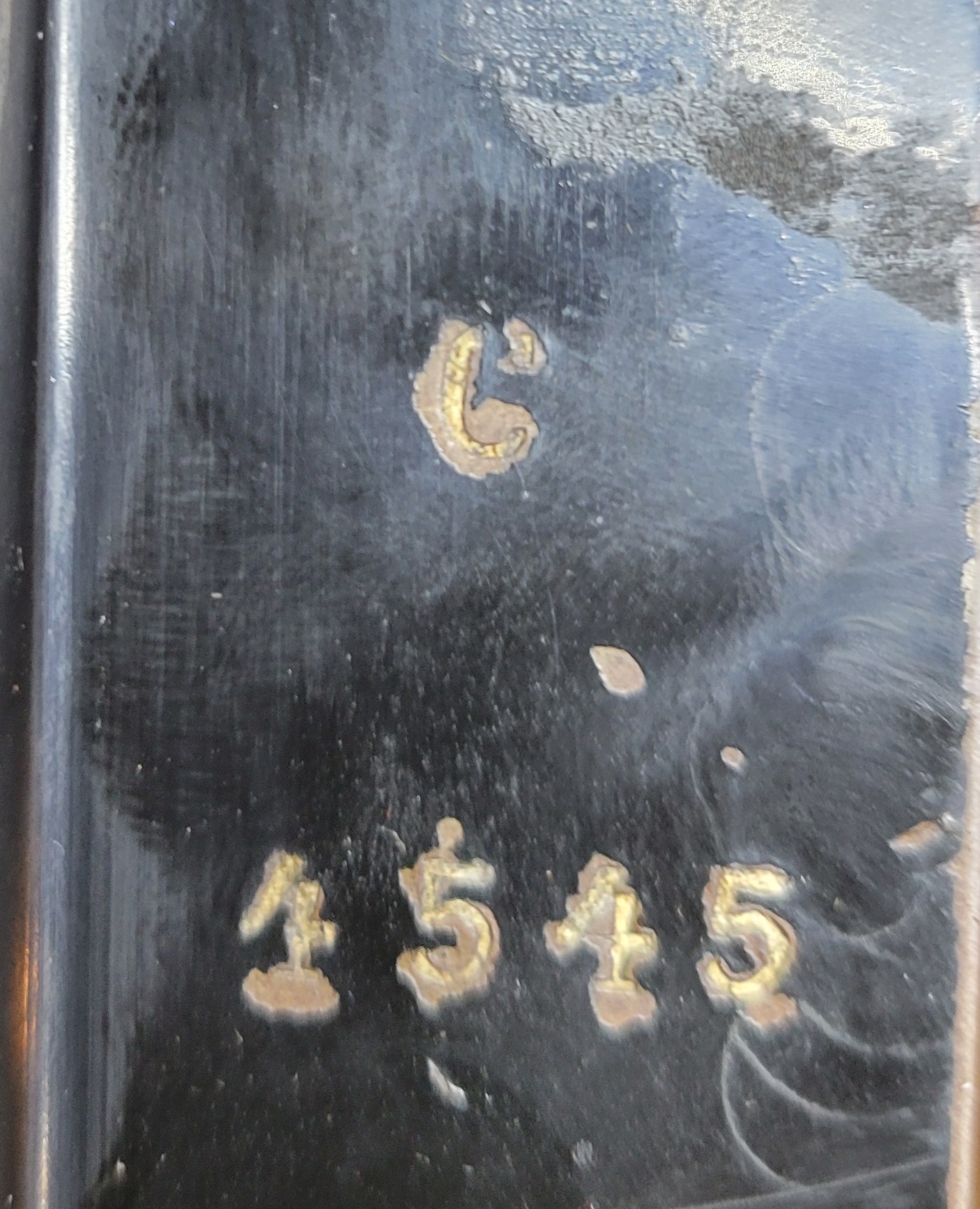 Figure 2 — The stamping on the base frame of my machine: the model letter C, and below it the machine number, 1545 (the first digit is worn and may be a 2).