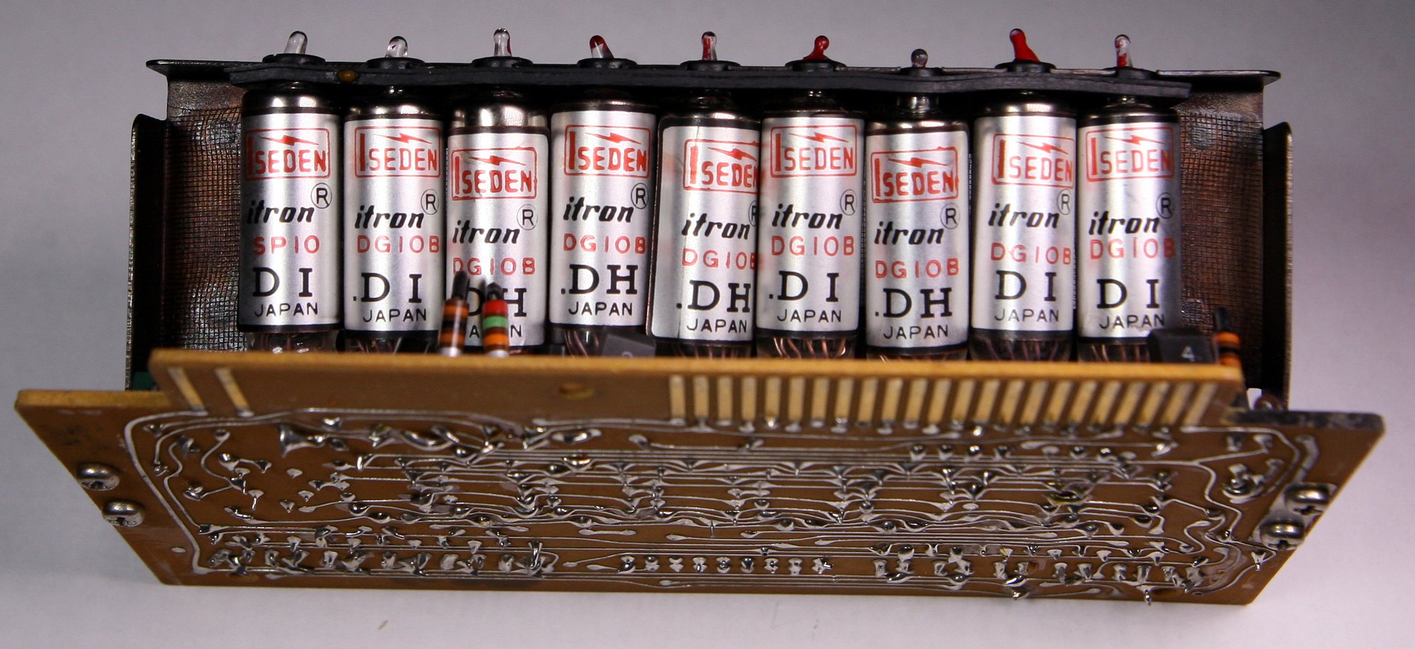 Figure 5 — What replaced the Nixie: the vacuum-fluorescent "Itron" tubes of a Sharp QT-8D Micro Compet of 1969. They glow blue-green and run from a few tens of volts.