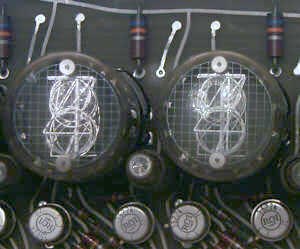 Figure 7 — Top-view Nixies, read through the domed end, in a Wang LOCI-2 of 1965. The tubes were made by National Electronics of Illinois.