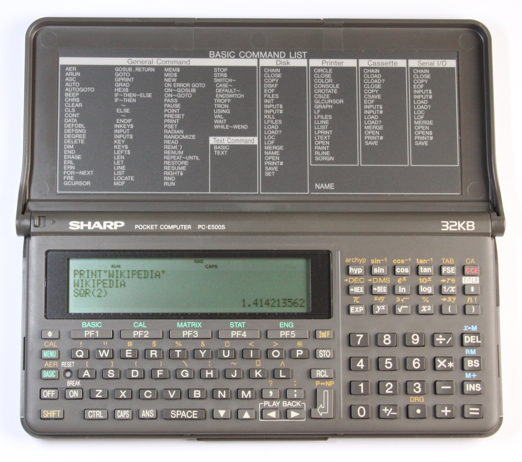 Figure 8 — The Sharp PC-E500S, a late-1980s and 1990s machine with a four-line display and a BASIC command list printed inside the lid.