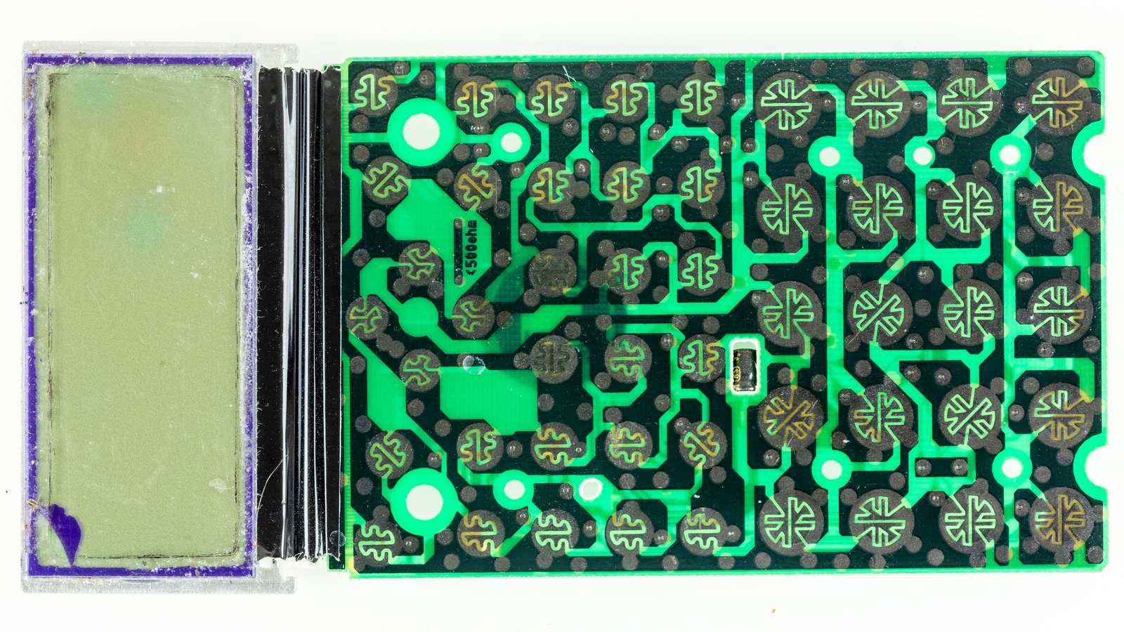 Figure 3 — Inside a Casio fx-991ES, the fx-82ES's larger sibling: the display at the left and the board with the contact pads that the rubber keys press.
