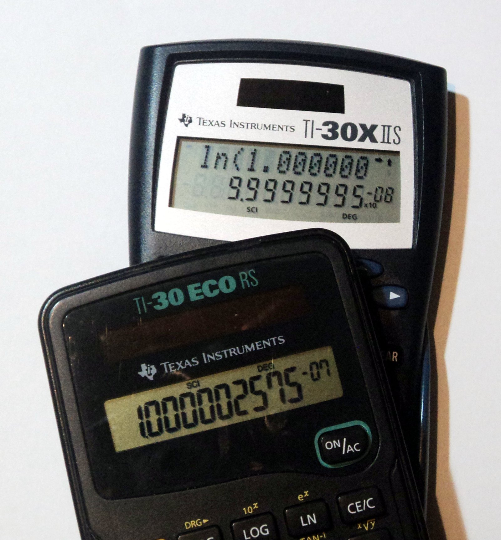 Figure 16 — A logarithm bug on a TI-30X IIS, the natural logarithm of a number just above 1 giving a wrong result, photographed beside a TI-30 ECO RS.