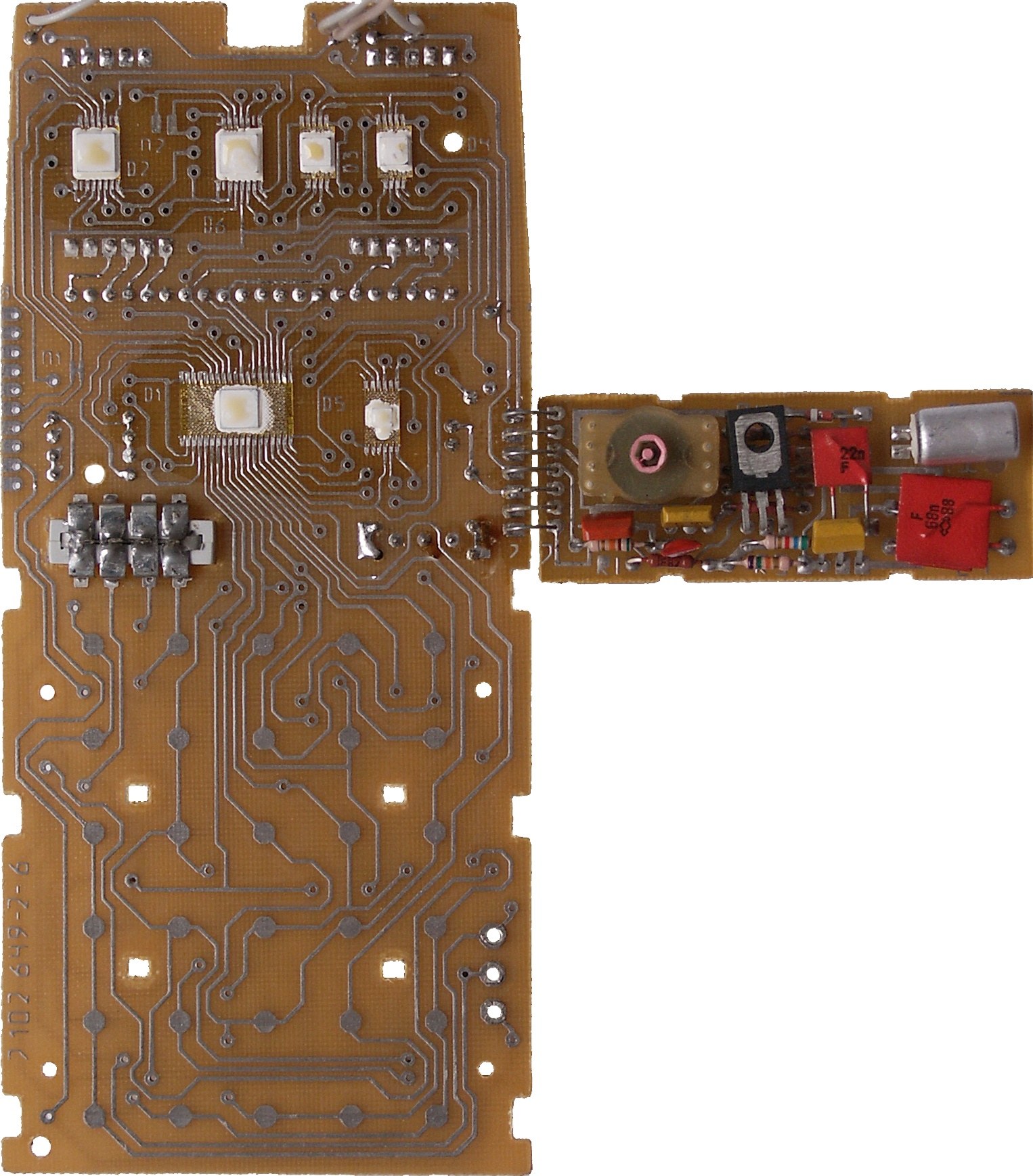 Figure 7 — The rear of an MK-61's main board, with the chips mounted bare and covered, and the separate converter board beside it.