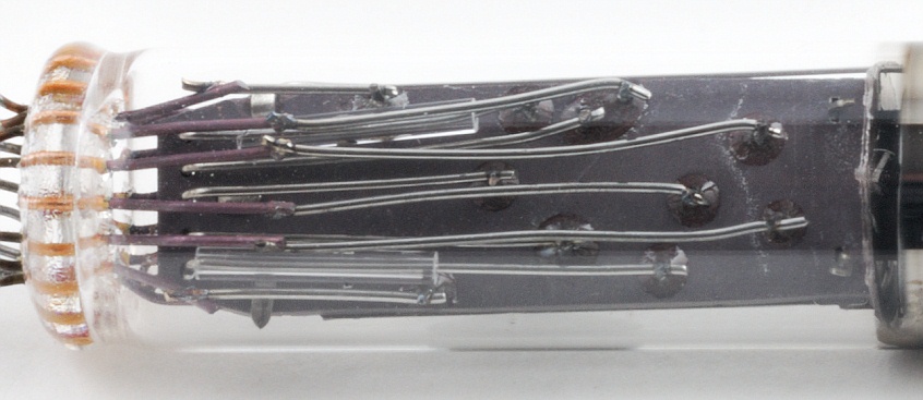 Figure 3 — The base of an Ise DG12B tube: the fine leads that carry the filament, grid and seven segments through the glass. On single-digit tubes the filament pins are found by their low resistance.