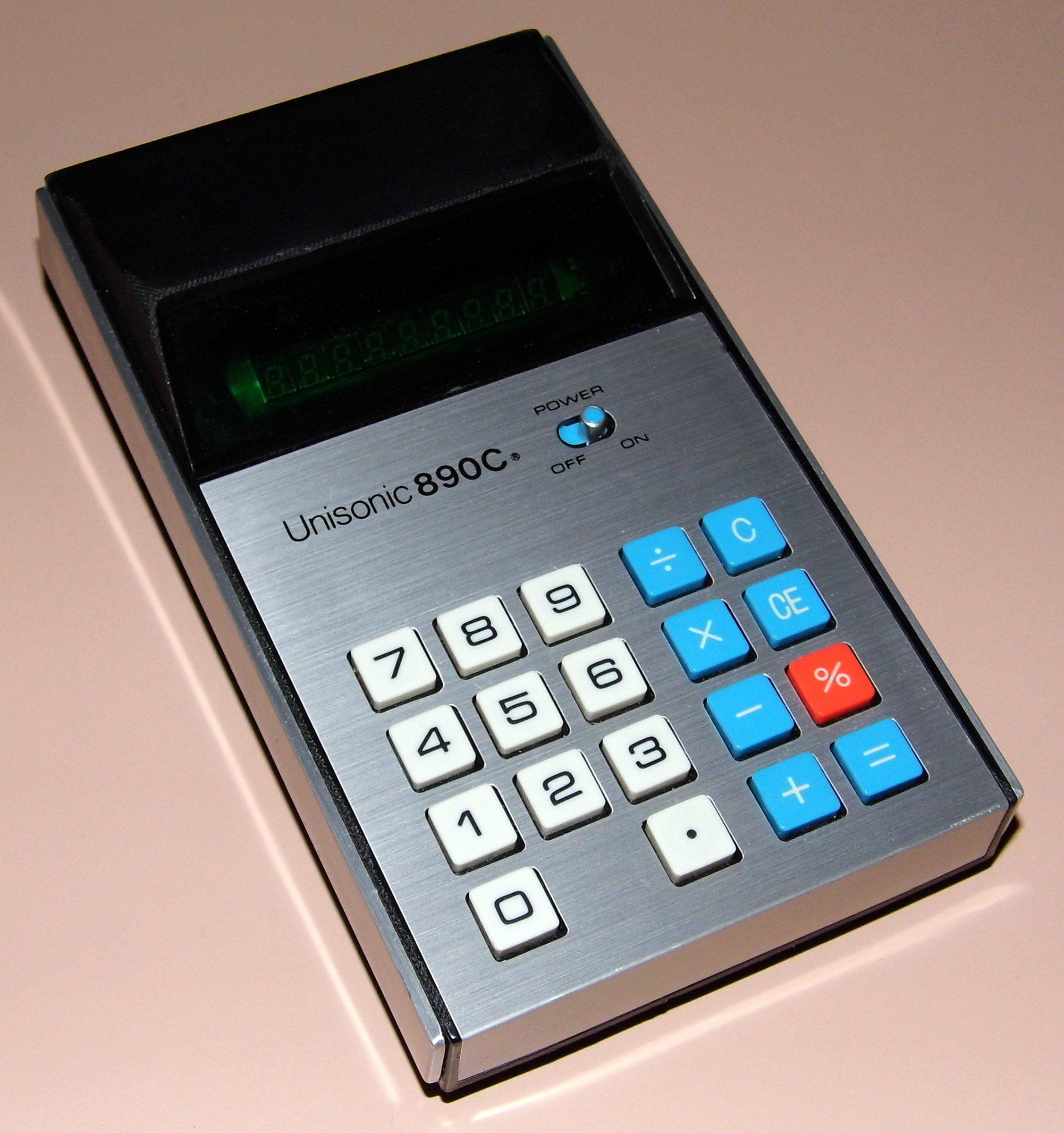 Figure 3 — A Unisonic 890C pocket calculator of about 1975, with a fluorescent display and a sealed battery pack: one of the hundreds of inexpensive VFD machines sold under American brand names.
